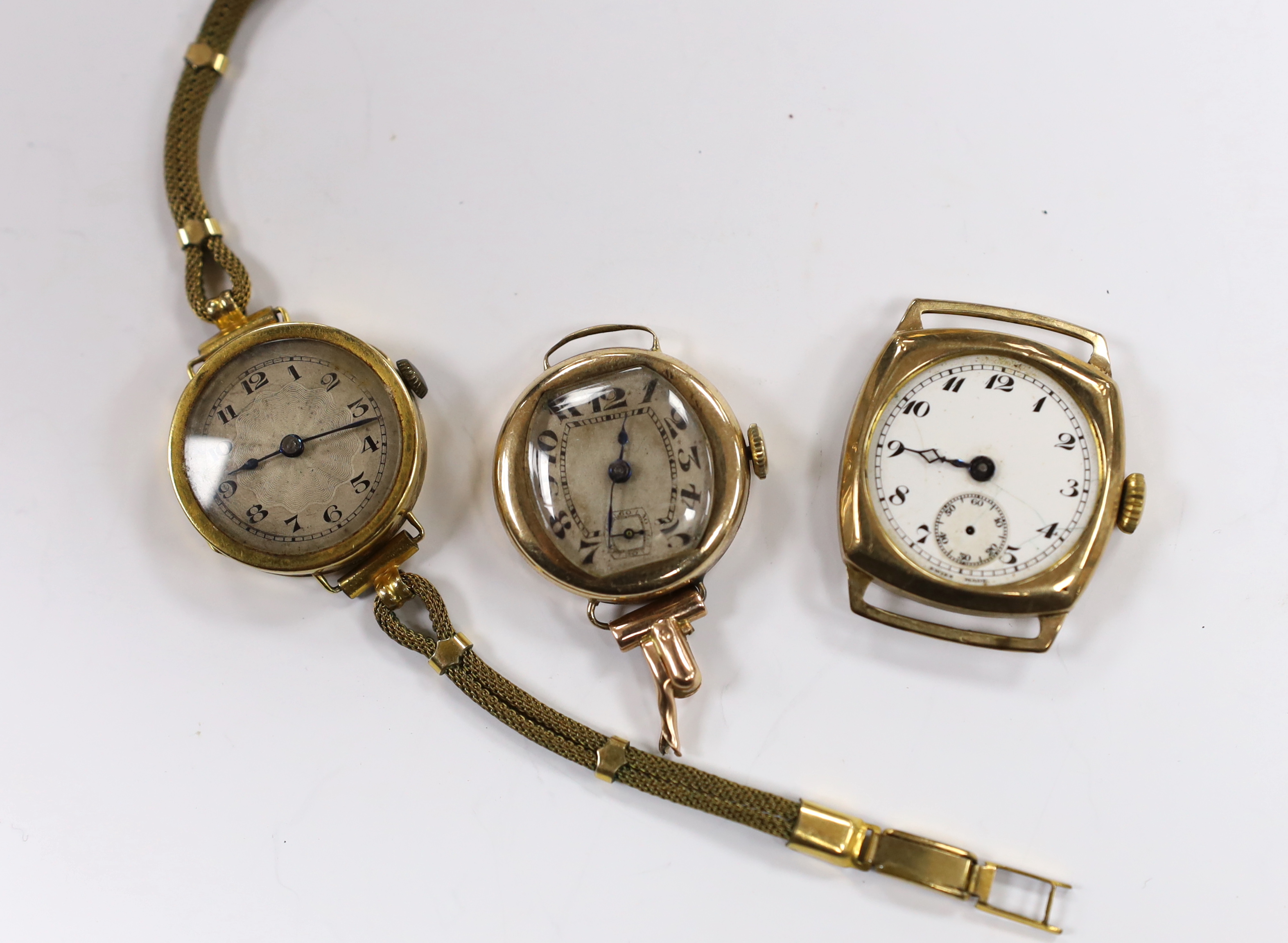 A lady's 18ct gold manual wind wrist watch on a twin fabric strap and three similar 9ct gold wrist watches.